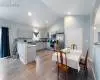 Kitchen with light hardwood / wood-style flooring, gray cabinets, stainless steel appliances, and kitchen peninsula
